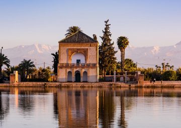 Saadian pavilion,Menara gardens and Atlas in Marrakech, Morocco, Africa at sunset. Water reflection.